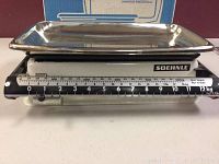 Front view of Soehnle kitchen scale with stainless steel tray and mechanical dial showing weight up to 12 kg.