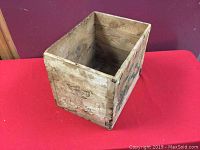 Wooden tea crate viewed diagonally showing interior, construction details, and wood condition.