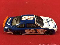 Blue and white diecast NASCAR race car model with number 56 and Tenneco logo viewed from side angle.