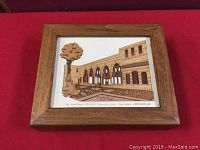 Closed wooden storage box showing framed inlay artwork of Azem Palace in Syria on the lid against a red surface.