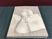 Cover of the book showing a black-and-white portrait of Whitney Houston and the title 'Whitney Tribute to an Icon'.