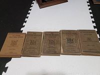 Five antique educational books laid out horizontally. Includes The Ontario Public School Speller and four Ontario Readers (First to Fourth book). Covers are tan cloth with brown titles and graphics.