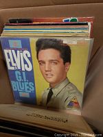 Box of vintage vinyl records featuring Elvis Presley's G.I. Blues as front record