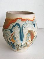 Front and side view showing blue, orange and cream swirl glaze on Nemadji pottery vase.