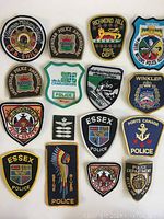 Sixteen badges and patches including police and fire department designs