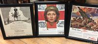 Photo of three framed World War II war advertisement prints including 'My Children', 'Spend While They Save', and 'Deadly Blow' artwork.