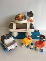 Full set showing main space station, figures, vehicles, and accessories on blue base