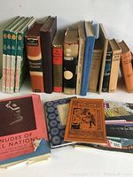 Photo showing the full set of twenty vintage books arranged on a surface. Includes a variety of titles, colors and sizes, with well-worn covers and spines.