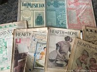 Collection of nine antique magazines laid out showing covers and edges