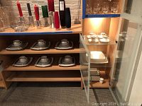 Overall view of shelving with china set displayed