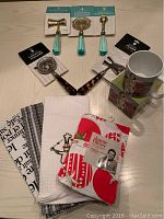 Photo showing full set of kitchen and barware items including bar tools, mugs and towels