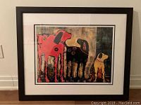 Frontal photo of entire framed print showing three abstract dogs in bold colors with mat and frame.