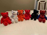 Front view of six NHL beanie bears seated on table showing various colors and tags.