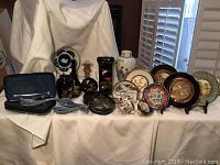 Full lot display showing all ceramics, figurines, and lacquerware pieces against a white cloth backdrop.