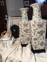 Photo showing entire lot with Buddha head, teapot, and two vases arranged on white fabric.