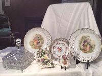 Overall set of Dresden German servingware and Rosenthal vase arranged on white cloth, showing reticulated plates, bowls, basket, pin dish, glass bud vase, and crystal candy dish.