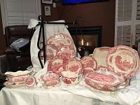 Overall view of multiple pink transferware pieces displayed on cloth