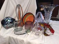 Overview of multiple art glass pieces including Murano basket vase, bowl, egg paperweight, clear vases, frosted bowl, Italian and German trinkets.