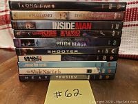 Photo of 10 action DVDs stacked showing titles on spines.
