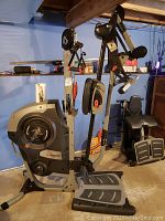 Assembled Bowflex Revolution home gym showing main frame, resistance housing, foot plates and cable arms