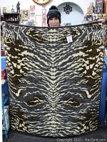 Full view of the blanket showing tiger stripe pattern with brown, cream, and muted olive colors.