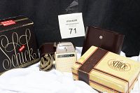 Vintage men's Schick electric shaver with leather case, electric cord, brush, and original boxes shown on white cloth with seller number.