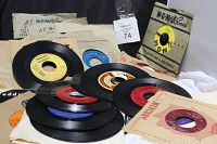 Image showing a pile of vintage 45 RPM vinyl records with various colored center labels along with paper sleeves from different record companies such as MGM, Mercury, and Mercury Records.