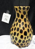 Front angle of leopard spotted vase showing full height and pattern.