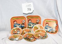 Photo displaying the complete set of three Raggedy Ann and Andy trays and seven saucers on a white background with the MaxSold tag visible.