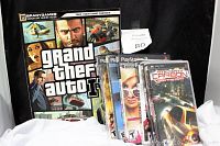 Photo of BradyGames Signature Series Guide for Grand Theft Auto IV and seven assorted video game cases including PSP and PlayStation 2 titles.
