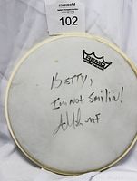 Front view of the drumhead showing the autograph and message.