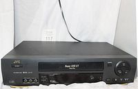 Front view of JVC Super VHS Player with branding and ports visible.