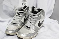 Front angle view of pair of silver, black and white Nike Force high tops showing front, sides, laces and tongue logo.