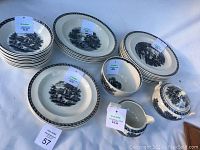 Photo showing plates, bowls, tea cups, saucers and cream/sugar bowl with Wedgwood dealer stickers