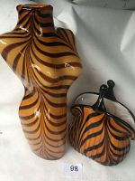 Photo showing the 14-inch bust shaped vase with tiger stripes alongside the smaller handbag vase displaying their size difference and pattern details