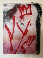 Front view of abstract mixed media painting showing red spray paint designs including a crown, and distressed canvas edges.