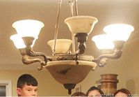 Chandelier installed and lit, showing all six lights (two bulbs out in photo but all work)