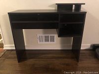 Front view of dark walnut faux wood desk showing open shelves and overall structure