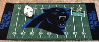 Carolina Panthers 30" x 70" anti-slip backed throw rug showcasing midfield logo and yard lines.