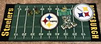 Full view of the Pittsburgh Steelers football field throw rug displaying logos, yard lines, LEGO-like player mini figures, and Steelers circular logos.