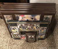 Four different wooden plaques with Pittsburgh Steelers player trading cards and photos shown stacked on carpet.