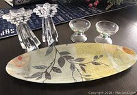Full view of set showing one decorated glass tray, two star-shaped clear glass candle holders, and two small pudding bowls with holly design.