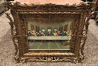 Full view of framed The Last Supper artwork showing the detailed gold decorative frame and the painting of Jesus and disciples at the table.