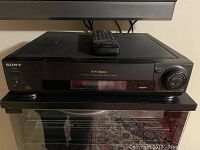 Sony VHS VCR SLV-730HF with remote control on top, unit closed.