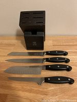 Knife block standing with four knives removed for display