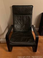 Front view of black leather Ikea Poang chair showing cushion and armrests.