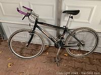 Full side view of the black Trek 930 System 2 mountain bike with purple handle grips, gel seat, and knobby tires.