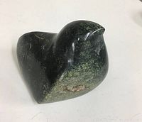 Front view showing the rounded body and beak of the hand carved stone puffin.