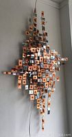 Full view of entire metal wall art sculpture on a white wall.