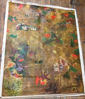 Full view of large unframed canvas laid flat on floor showing overall composition